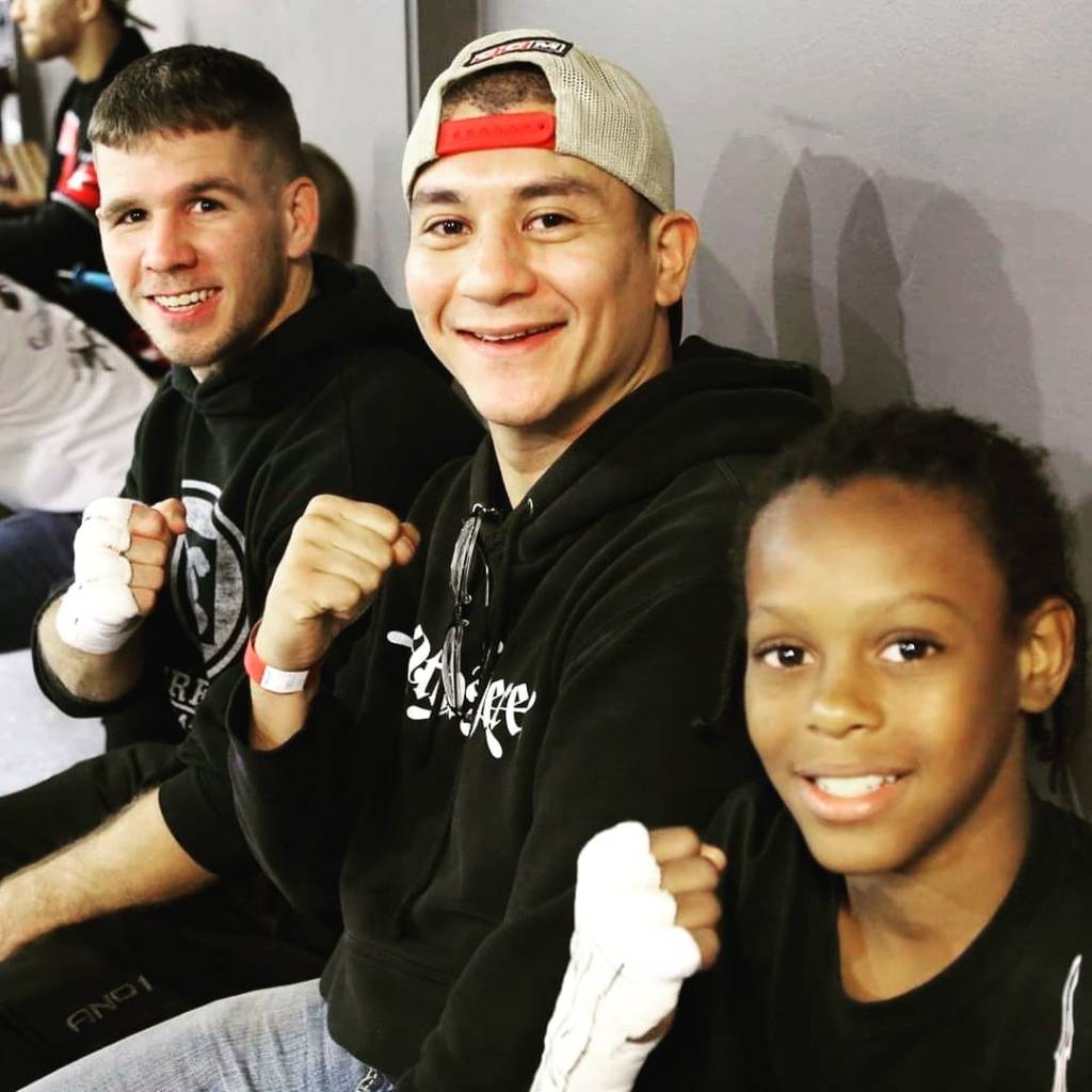 Head Coach, Willy Martinez, posing with fighters before their matches. 