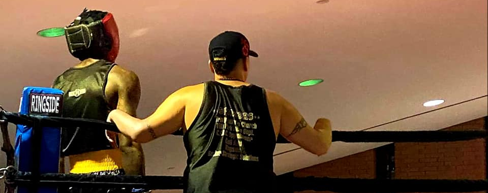 Head Coach, Willy Martinez standing with fighter, Doral Berry.